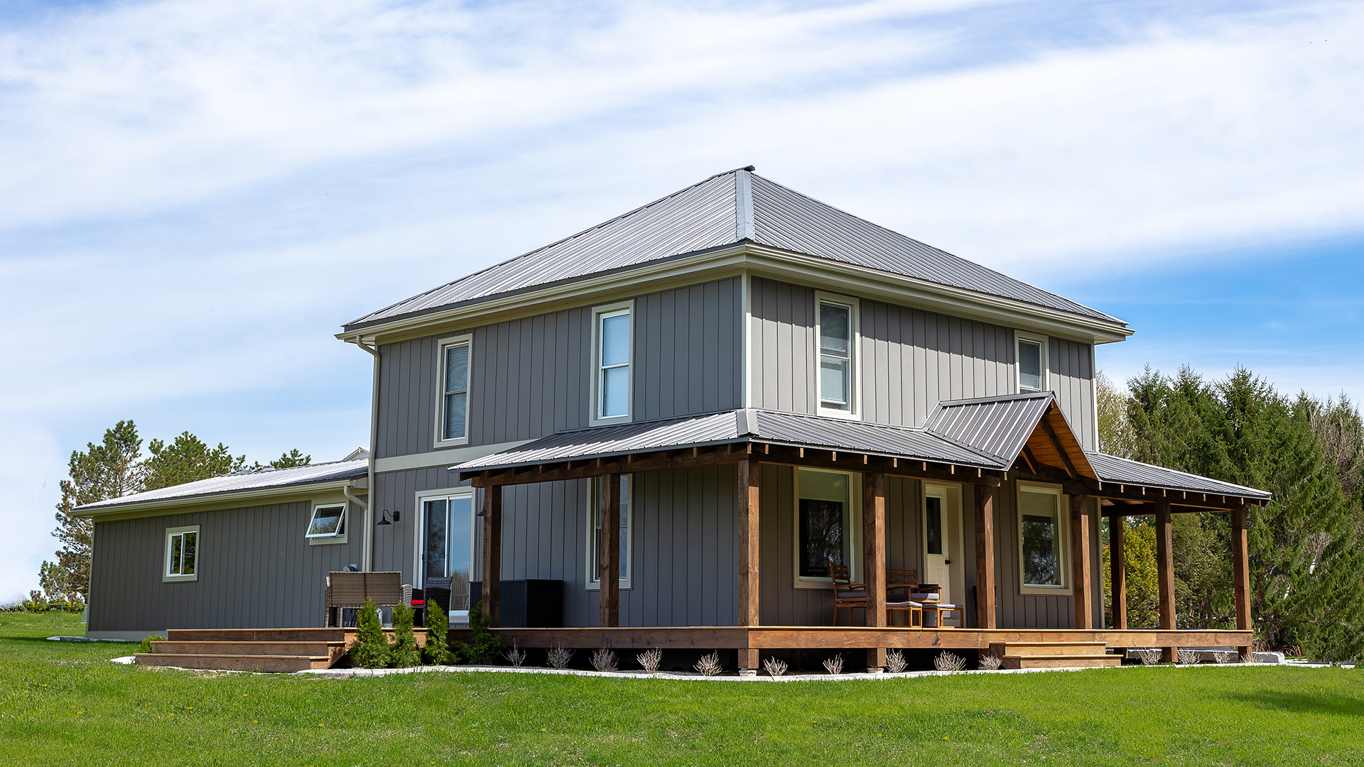 Timber frame exterior renovation project in Woodstock Ontario featuring custom siding and rebuilt porches